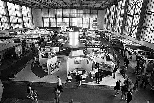 A black-and-white photograph of a trade fair from an earlier period, taken from an aerial view