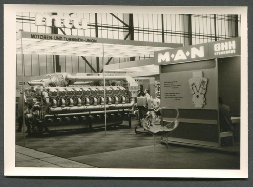 A historical picture of a fair stand of the Motors and Turbine Union, with a bit displayed turbine.